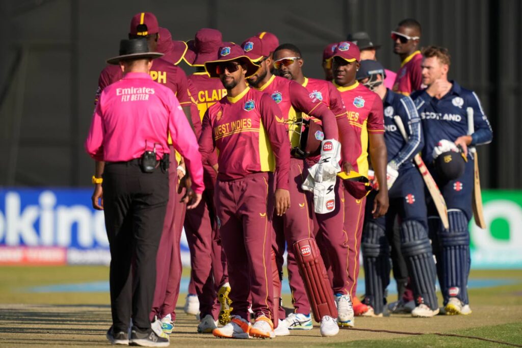 West Indies players shake hands after losing to Scotland in their ICC Men's Cricket World Cup Qualifier match at Harare Sports Club in Harare, Zimbabwe, on Saturday. - AP PHOTO