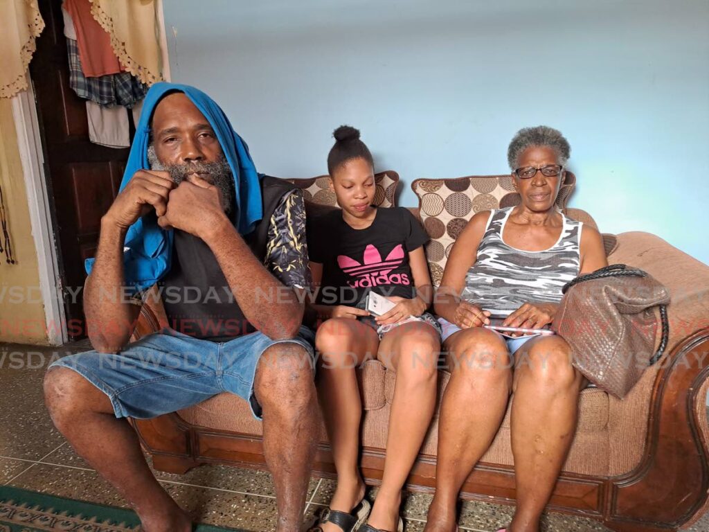 QUESTIONS: Relatives of Tacarigua teenager, Jorel Jordan Nathan, his uncle, Steve Nathan, left,  his elder sister Jeuel and his grandmother, Ann Nathan, at the family's home on Sunday.   - Jensen La Vende