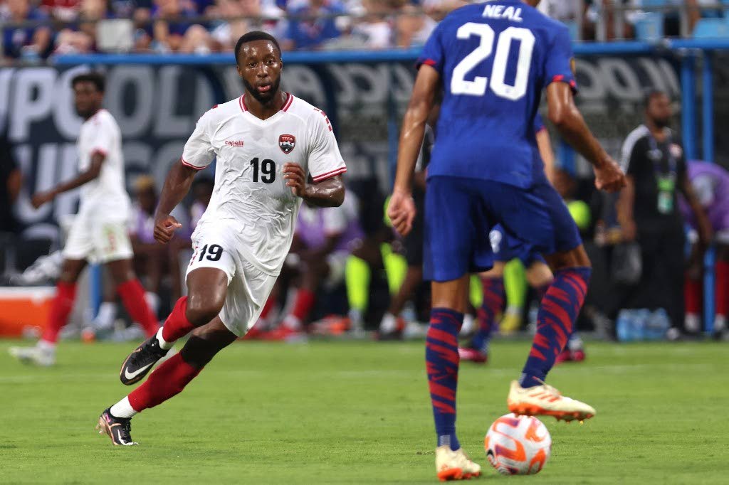 TT's Malcolm Shaw (L) defends against Jalen Neal of the United States during the second half of the Concacaf Gold Cup match at Bank of America Stadium onSunday. in Charlotte, North Carolina. - 