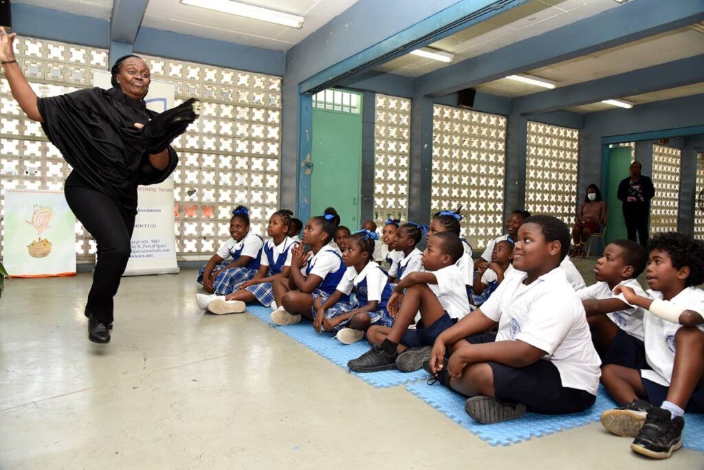 Arrow tutor and auditor Bridgid Richardson captivates the students of Excel Beetham Estate Government Primary School. - 