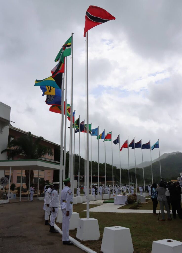 Flags of the Caricom member states flutter in the breeze under cloud-filled skies at the Chaguaramas Convention centre after a flag-raising ceremony. PHOTO BY ANGELO MARCELLE - 