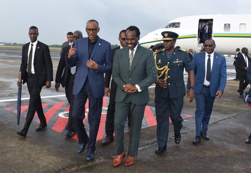 President of Rwanda Paul Kagame, left, is escorted by National Security Minister Fitzgerald Hinds on his arrival at Piarco airport on July 5. Photo: National Security Ministry Facebook page - 