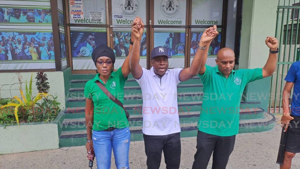 Public Servants Association (PSA) members Jennifer Frederick, Jude Davidson and Oral Saunders speak to other union members and media outside the PSA's headquarters on Abercromby Street, Port of Spain, on Friday. The group criticised PSA president Leroy Baptiste and called on the union to accept government's four per cent salary-increase offer. - JENSEN LA VENDE