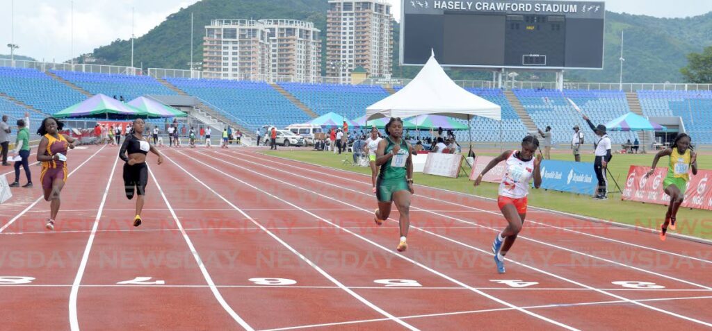 Kioni Devenish in lane 4 crosses the finish line to win heat 5 of the Girls' Under-18 100m at the NAAATT Junior Champs at the Hasely Crawford Stadium, Port of Spain on Saturday. - Anisto Alves