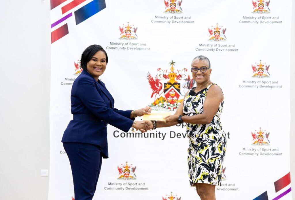 HANDOVER: Sport and Community Development Minister Shamfa Cudjoe, left, presents TTOC president  Dianne Henderson with a cheque at the Belmont Community Centre. PHOTO COURTESY SPORT MINISTRY - 