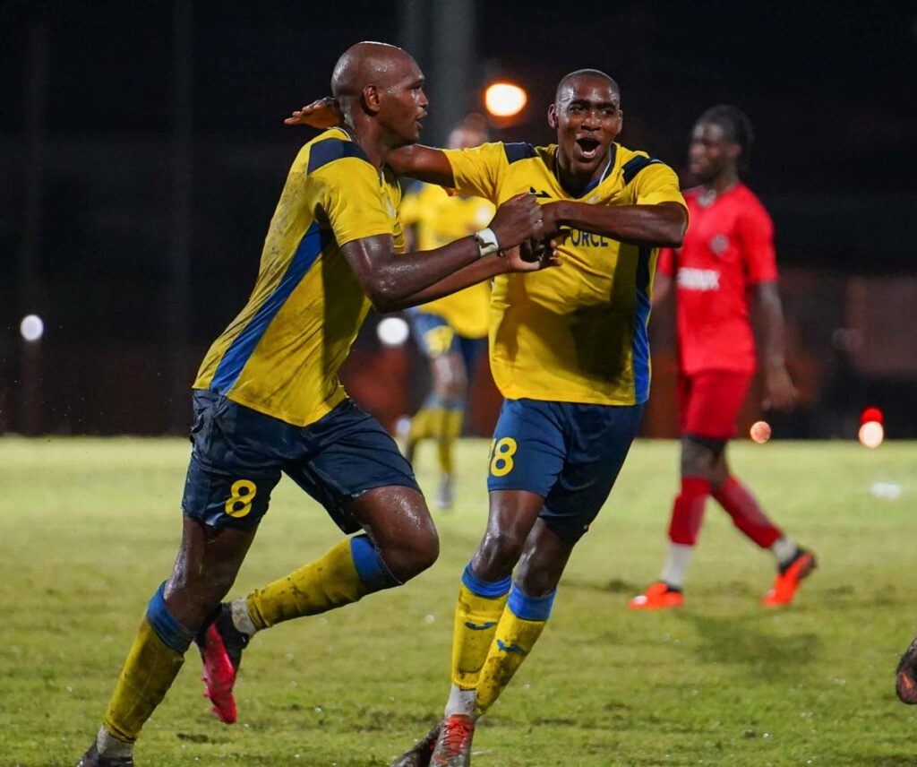 Defence Force FC’s Brent Sam and Reon Moore (R) celebrate a goal against La Horquetta Rangers during the final of the TT Premier Football League Knockout tournament, on Saturday night, at the Diego Martin Sporting Complex, Diego Martin. - TT Premier Football League