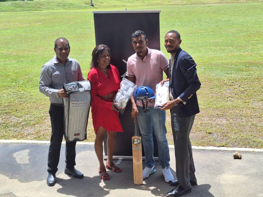 Minister Gopee-Scoon, left, PTRC Chairman Gowrie Roopnarine, second from left, and Councillor Lorant, right, present cricket gear to a representative of Trench Town Cricket Club  - SporTT