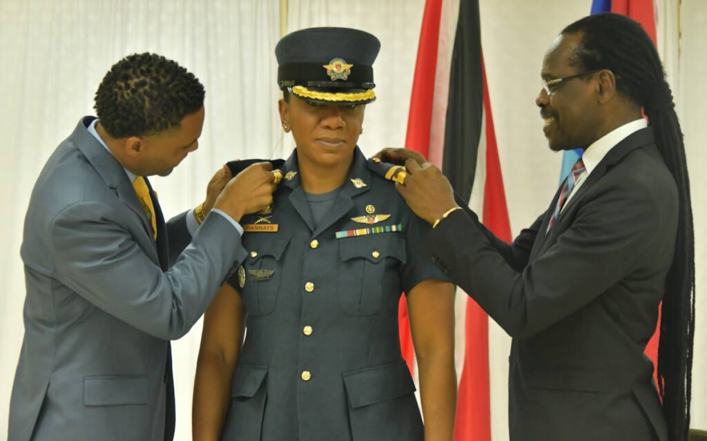 National Security Minister Fitzgerald Hinds (right) and Mr Hannays (spouse of Group Capt Kemba Hannays) affix badges of rank to commanding officer of the TT Air Guard, Group Captain Kemba Hannays at a promotion and appointment ceremony on  July 10.
(Photo courtesy Ministry of National Security) - 
