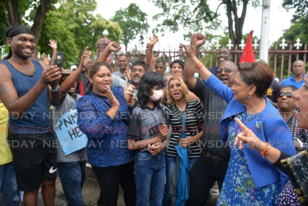 Opposition Leader Kamla Persad-Bissessar with protesters outside Parliament before the start of a sitting of the House of Representatives on Wednesday. - Anisto Alves