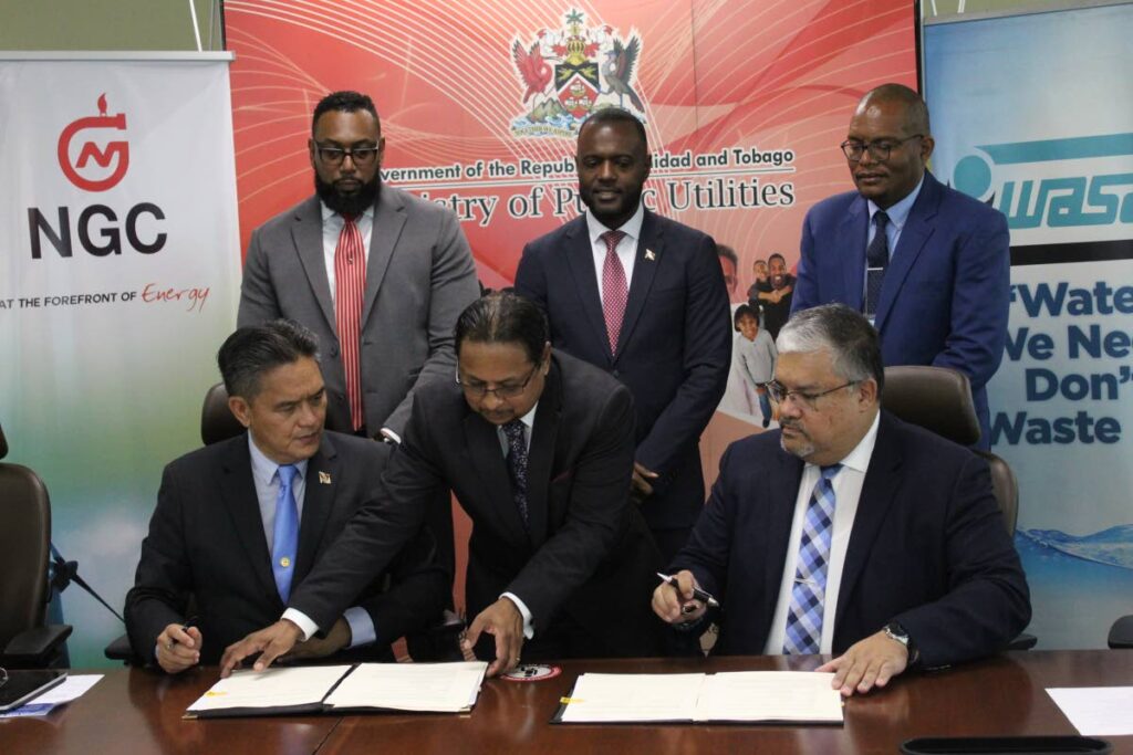 Front row, from left: NGC president Mark Loquan and WASA chairman Ravindra Nanga sign an MoU on collaboration between the two companies as Public Utilities Minister Marvin Gonzales, centre, NGC chairman  Dr Joseph Ishmael Khan, left, and WASA deputy chairman Alston Fournillier look on at back. - MINISTRY OF PUBLIC UTILITIES