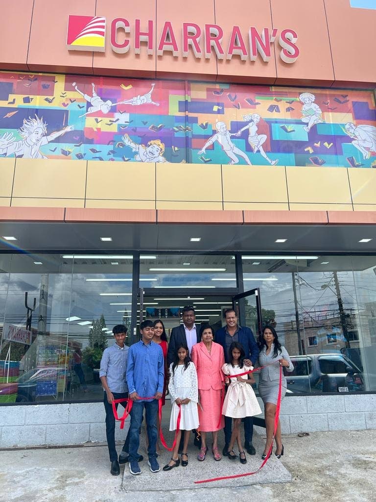 Vivek Charran (centre) and his family stand at the entrance to the newly-opened Charran's book store on Diego Martin Main Road, Diego Martin.
(Photo courtesy Charran's Bookstore) - CHARRAN'S BOOK STORE