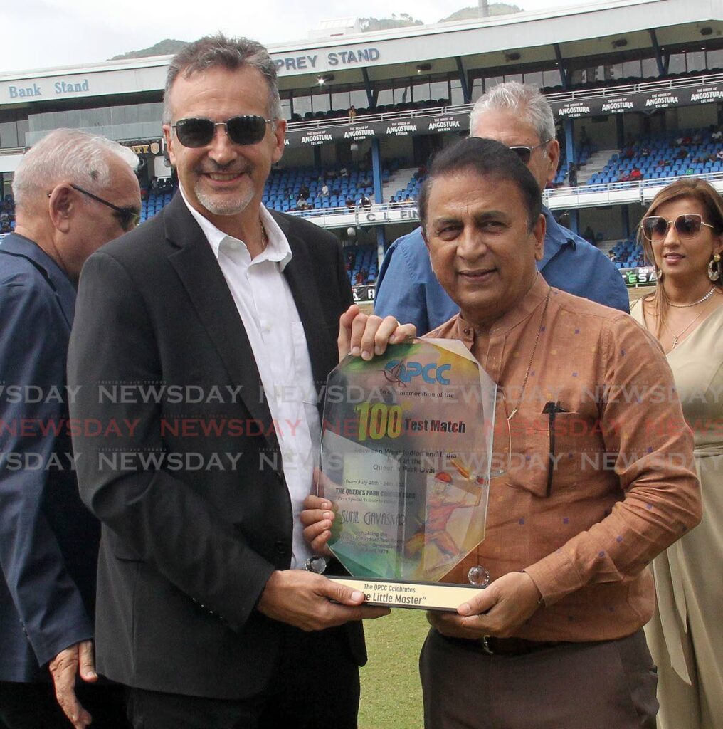 HONOURED: Queen's Park Cricket Club president Dr Nigel Camacho, left, presents a plaque to honour retired Indian batting legend Sunil Gavaskar during the tea break on the second day of the 2nd Test on Friday at the Queen's Park Oval in Port of Spain. PHOTO BY ANISTO ALVES - 