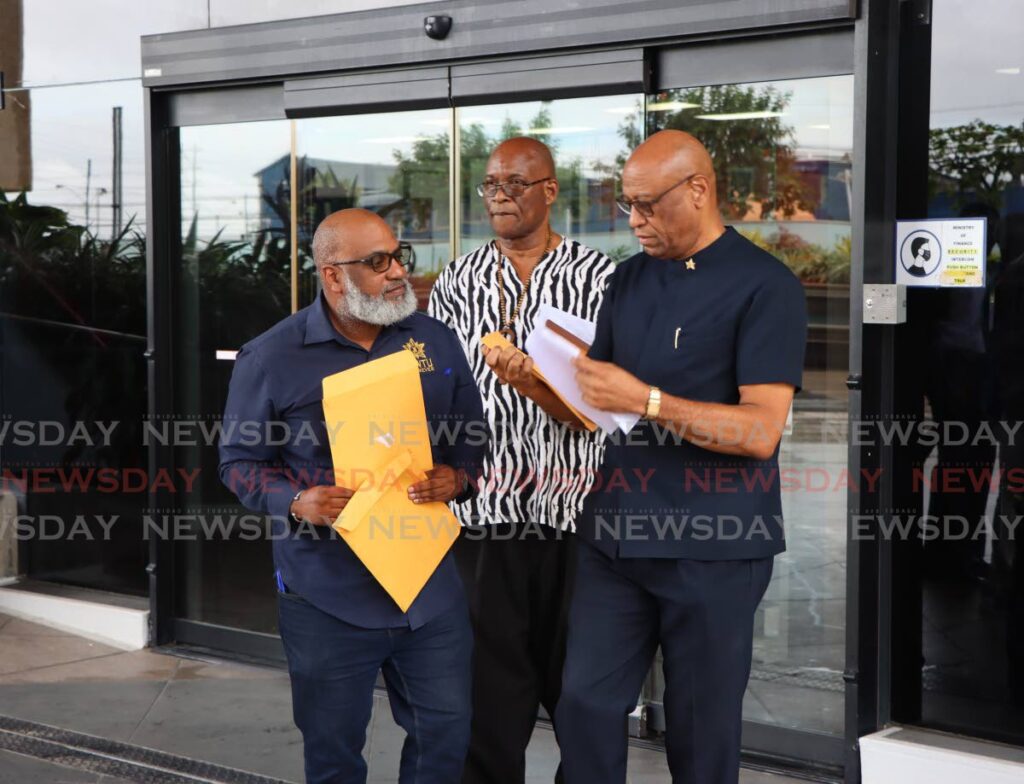 OWTU chief education & research officer Ozzi Warwick,  National Trade Union Centre General Secretary Michael Annisette and OWTU general secretary Ancel Roget, walk out of the Ministry of Finance after delivering a letter to Minister of Finance Colm Imbert on Monday.  - Angelo Marcelle