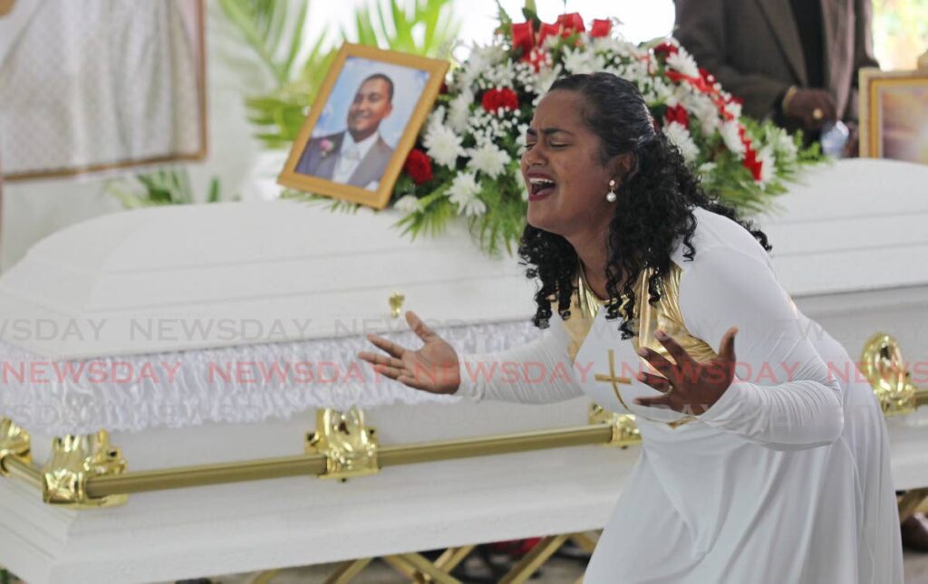 FAREWELL: Ruth Gobin, sister of deceased Allanlane Ramkissoon, performs a dance at his funeral at his Barrackpore home on Monday. Ramkissoon, an employee of Massy Energy Engineered Solutions Ltd died after being injured in an accident at NiQuan Energy's gas-to-liquids plant in Point-a-Pierre. PHOTO BY LINCOLN HOLDER - 