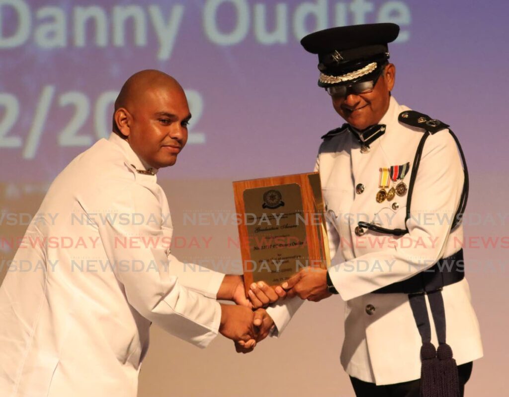 PC Danny Oudite receives a special award from TT Municipal Police Service ACP Surrendra Sagramsingh, at a graduation ceremony for 47 municipal police recruits at the Southern Academy for Perorming Arts, Todd Street, San Fernando on Wednesday. - Angelo Marcelle