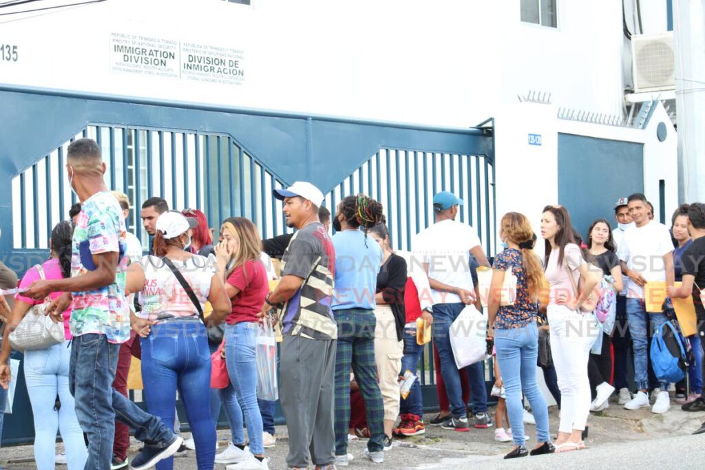 Venezuelans line up outside Immigration Division, Henry Street, Port of Spain to renew their work permits. - File photo by Grevic Alvarado
