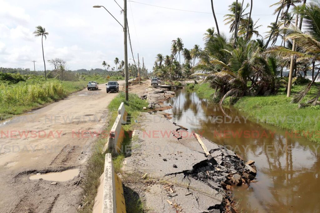 The condition of a section of the Manzanilla Main Road, right, and the temporary access road built for commuters on Friday. The reconstruction of the main road was launched by Minister of Works Rohan Sinanan on Friday. - ROGER JACOB