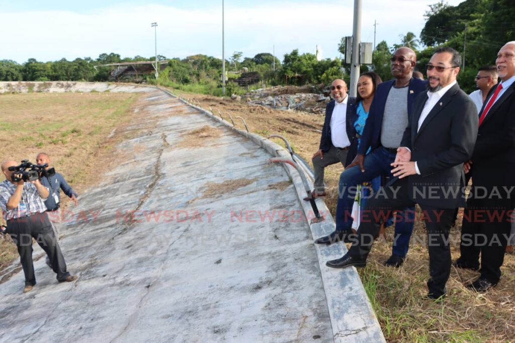 Minister of Energy Stuart Young second from right and Prime Minister Dr Keith Rowley look at the condition of the old Palo Seco Velodrome on Friday. At right is UDECOTT chairman Noel Garcia.  - Angelo Marcelle