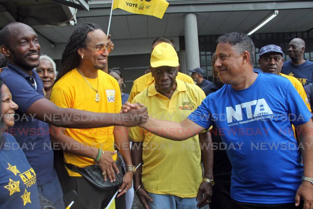 OWTU Pointe-a-Pierre branch president Christopher Jackman, left, and NTA leader Gary Griffith greet each other alongisde UNC candidate Michael Ali Bocus and Jack Warner in Marabella on Saturday. - Lincoln Holder