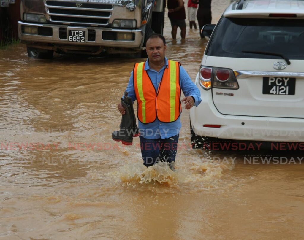 FILE PHOTO: Sangre Grande Regional Corporation Chairman Anil Juteram walks through floodwaters on Neeraanjan Street, Sangre Grande, as he checks on affected residents on November 9, 2022. - 