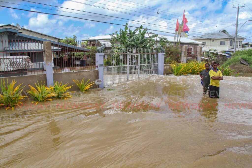 Residents on a flooded street in Woodland on June 13. - ANGELO MARCELLE