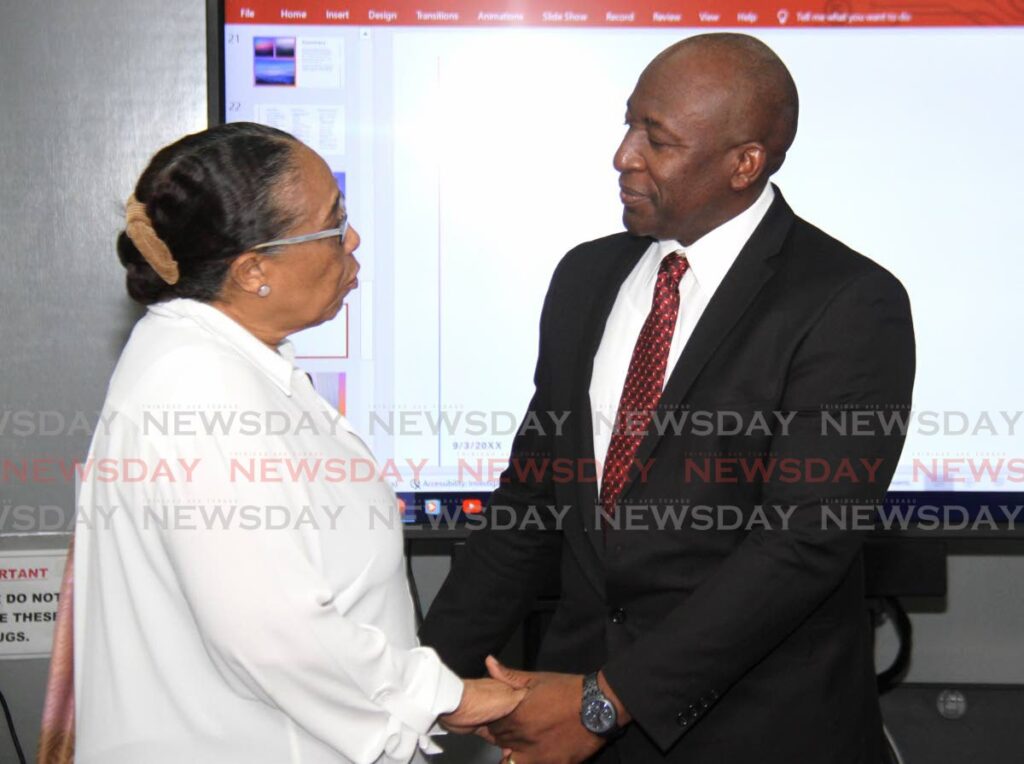 Project GRACE consultant Joanne James speaks with acting Deputy Commissioner of Police for intelligence and investigations Curt Simon during the project GRACE school supply distribution at the San Fernando Police Station. - AYANNA KINSALE