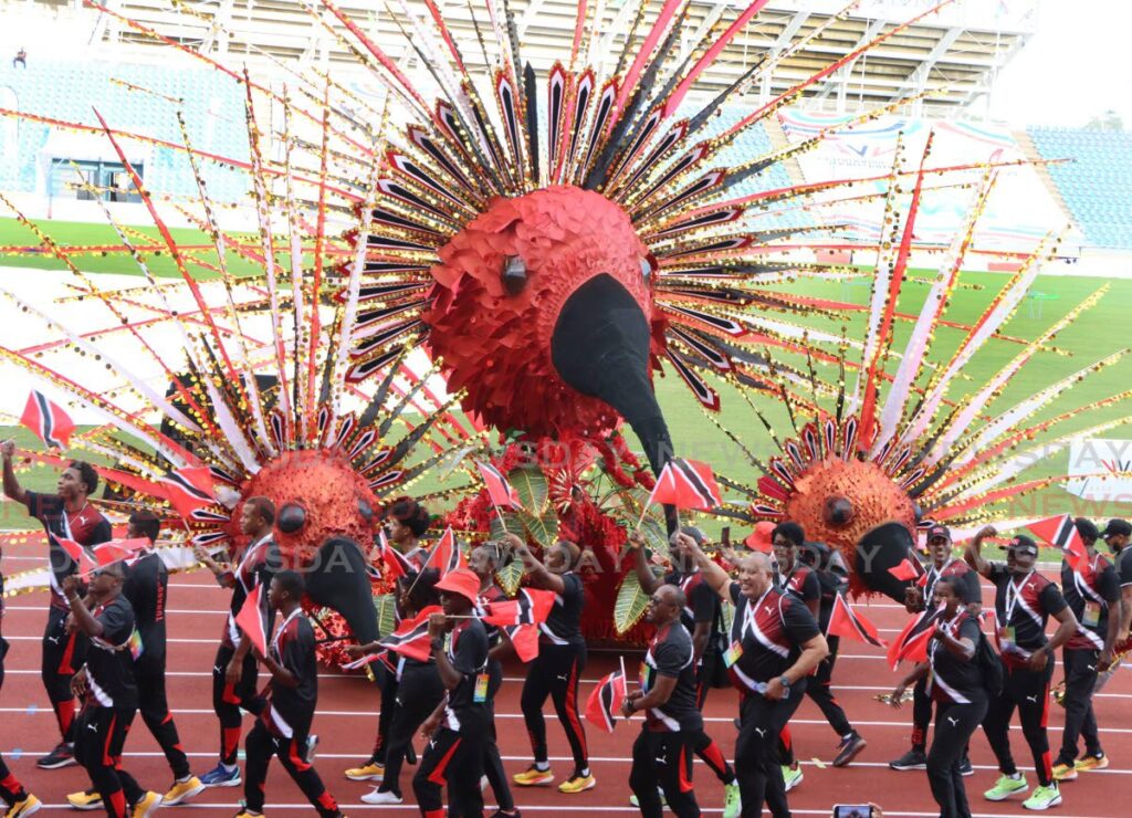 Team Trinidad & Tobago dance at the opening ceremony of the 17th Commonwealth Games, Hasely Crawford Stadium, Port of Spain on Friday.  - Photo by Angelo Marcelle