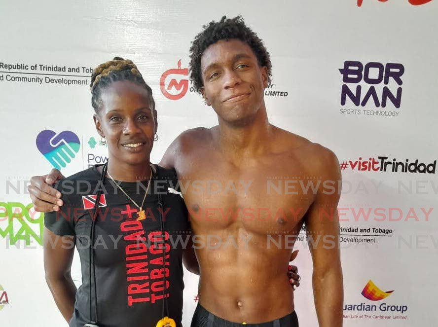 Commonwealth Youth Games gold medallist Nikoli Blackman, right, hugs TT swim coach and former national swimmer Sharntelle McLean after winning 200m free gold at the National Aquatics Centre, Couva, Sunday. - Photo by JONATHAN RAMNANANSINGH