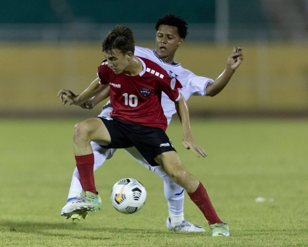 Trinidad and Tobago's Caden Trestrail shields the ball from his Honduran opponent during their Concacaf Under-15 Championship match on Sunday evening.  - TTFA Media