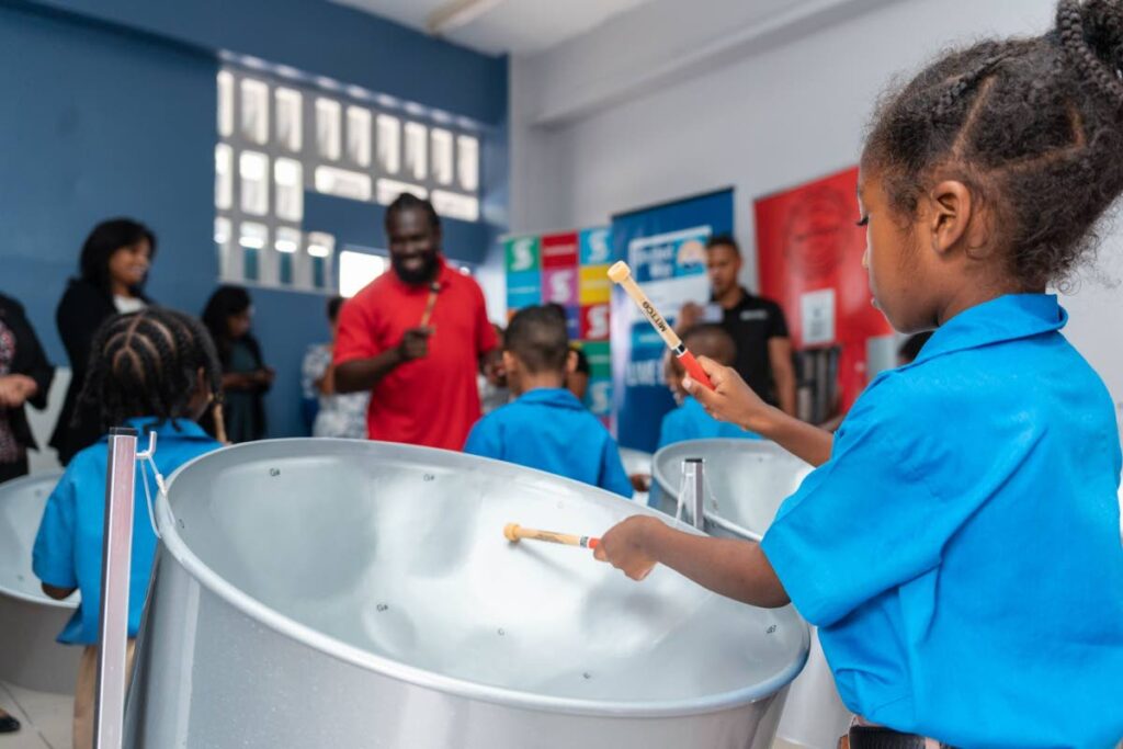 A pupil of Mucurapo Boys enthusiastically plays the pan during a class with music teacher Kyshon Frithr. The school’s pans were donated by Scotiabank through a collaboration with United Way. - 