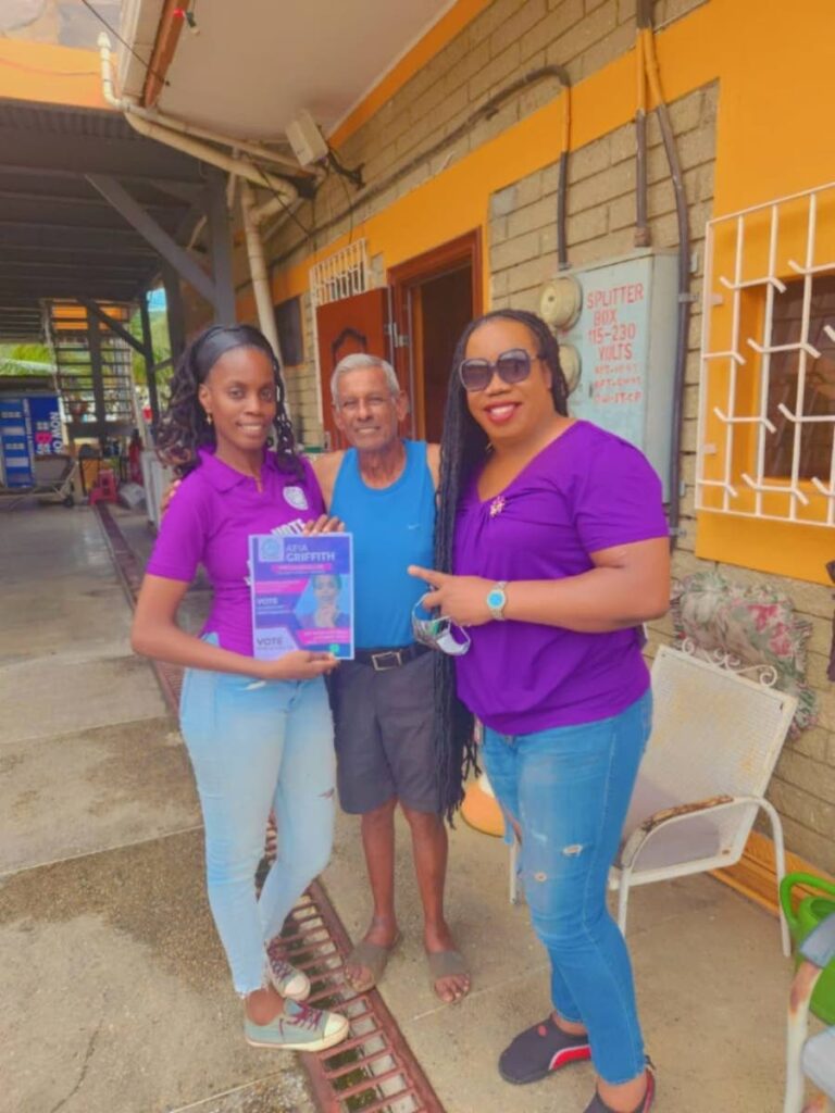 Afia Griffith, Unity of the People (UTP) candidate for Febeau/Bourg Mulatresse, left, and UTP leader Nikocy Phillip, right, with a supporter. - 