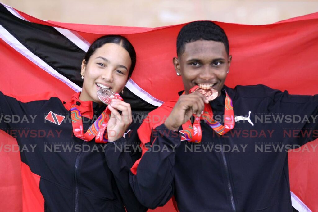 Makaira Wallace, left, and Syndel Samaroo with their Commonwealth Youth Games cycling medals at the National Cycling Velodrome, Couva, Thursday. - Lincoln Holder
