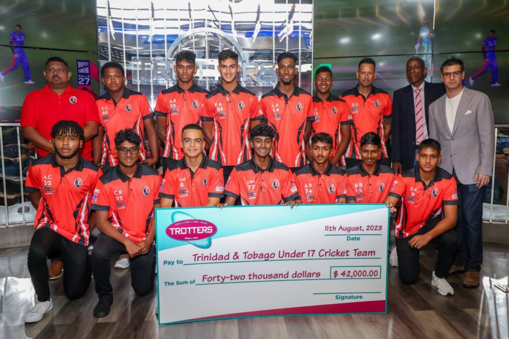 Members of the TT U17 cricket team with Trotters Group director Matthew Sabga, right, and Group general manager Cleaon Greene, second from right,. Trotters sponsored the team $42k for the CWI U17 Rising Stars 50-Over and two-day competitions.  - Daniel Prentice