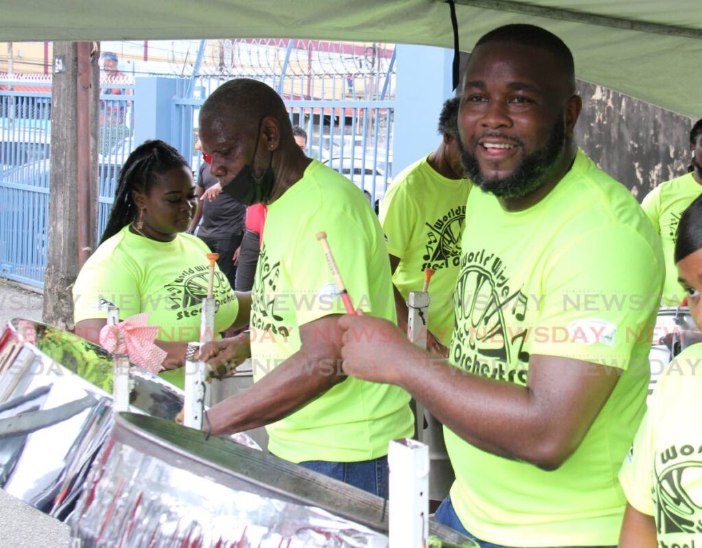 World Wide Steel Orchestra pannists perform Olatunji Yearwood's Engine Room during the World Steelpan Day celebrations along Piccadilly Street, Port of Spain on Friday. - Ayanna Kinsale