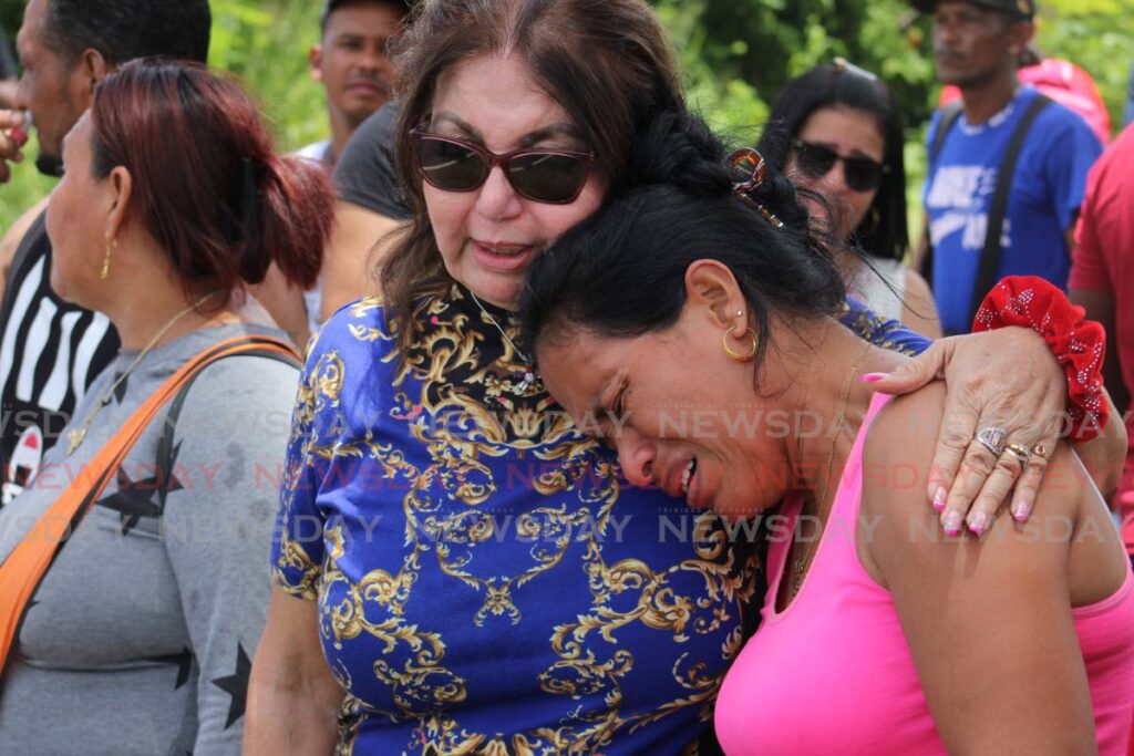 Anny Dique, a Venezuelan with a work permit issued by the TT government in 2019 cries over the deportation of her son while being comforted by Yesenia Gonzalez - Grevic Alvarado