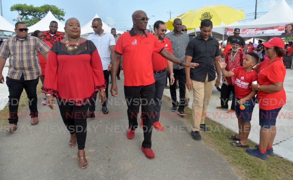 Prime Minister Dr Keith Rowley and lady vice chairman Camille Robinson-Regis greet supporters at Constantine Park, Macoya on Saturday. - Anisto Alves