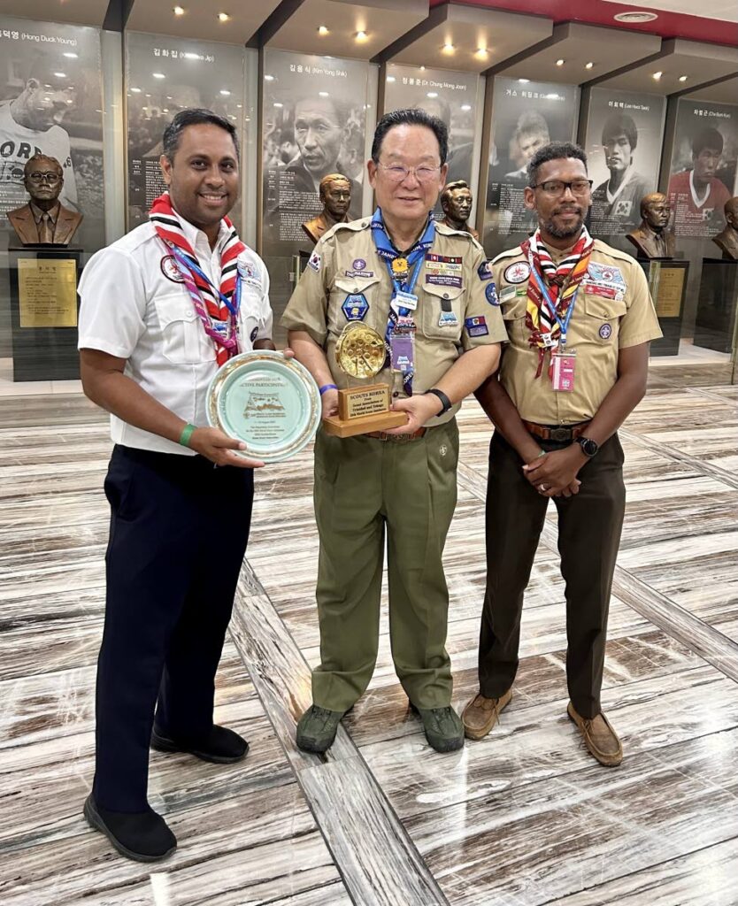 Head of Contingent Dr Jorrel Bisnath, Camp Chief South Korea Simon Hang-Bock Ree , and National Scout Commissioner Mark Ainsley John after exchanging tokens of appreciation  - Mark John