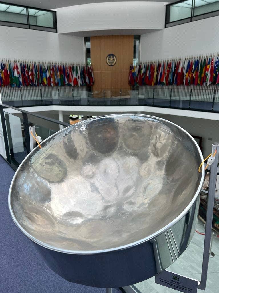 Pan from the walkway opposite the entrance to the court room at the International Ttribunal of the Law Of the Sea. At base right of photo, a plaque highlights a brief write-up about Trinidad and Tobago's pan gift to the ITLOS. Also in photo is the ITLOS  logo and flags of member states. - 