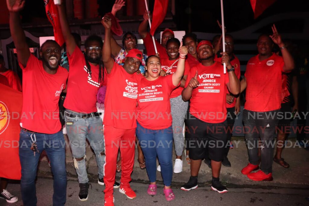 Successful PNM Arima Borough Corporation candidates Sheldon 'Fish' Garcia third from left and Jeniece Scott, embrace each other while celebrating with supporters and team members on Malabar Road on Monday night. Garcia was the only defector candidate that was victorious. PHOTO:ANGELO MARCELLE 