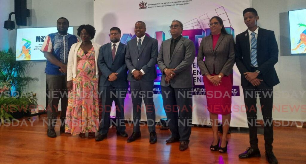 Minister of Youth Development and National Service Foster Cummings, centre, with ministry officials and and youth worker conference facilitators at the ministry's launch of its Youth Week activities at the UWI's Teaching and Learning Centre, St Augustine, on Tuesday.  - PAULA LINDO