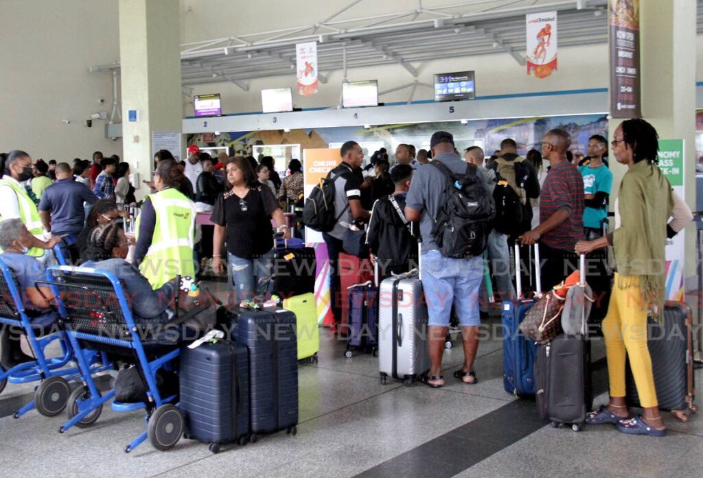 Caribbean Airlines (CAL) passengers wait for information after their flights were cancelled at the Piarco International Airport on Sunday.  - Photo by Ayanna Kinsale
