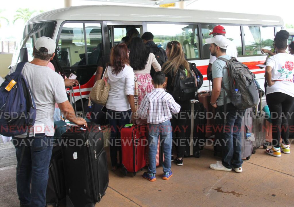 CAL passengers board a shuttle after their flights were cancelled at Piarco International Airport last weekend.  - Ayanna Kinsale