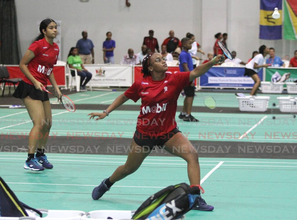 Amara Urquhart, right, returns the shuttle as girls U-17 doubles teammate T'Shelle Barnes looks on during the Carebaco junior tournament, at the National Racquet Centre, Tacarigua, Sunday. - Ayanna Kinsale