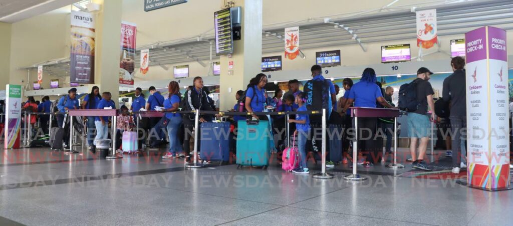 Members of the Barbados Badminton Association are about to check-in at Carbbean Airlines (CAL), Piarco International Airport on Monday as the airline tries to recover from 60 cancelled flights over the weekend. - Angelo Marcelle