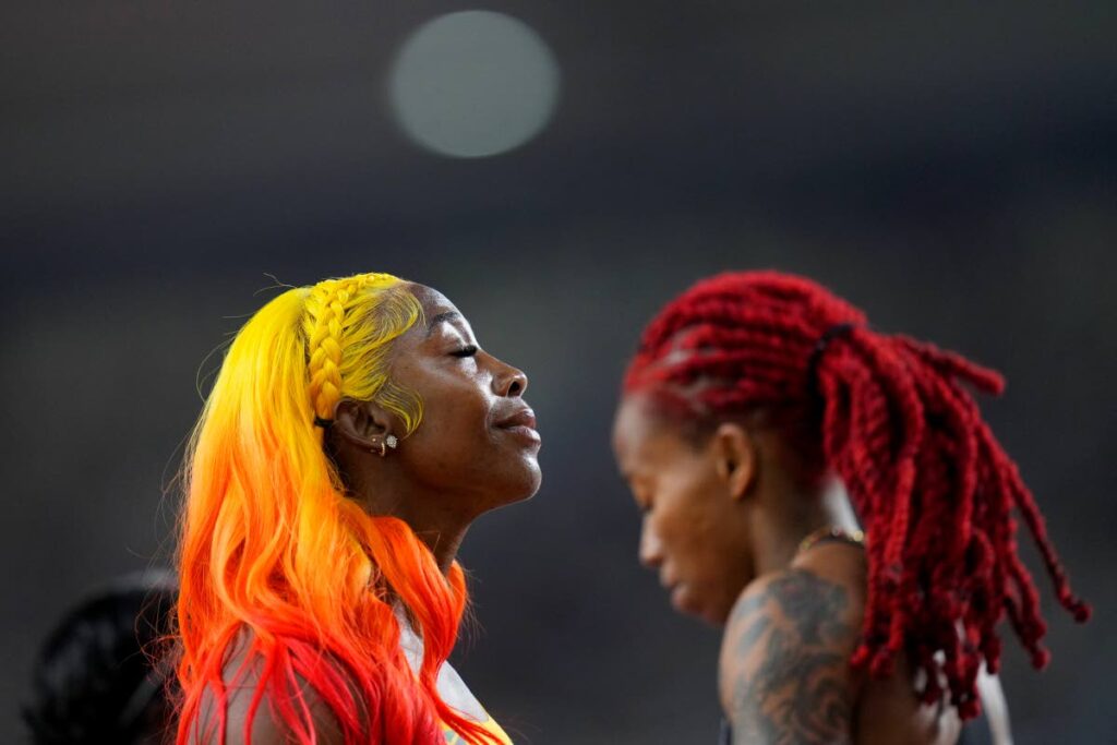 Jamaican Shelly-Ann Fraser-Pryce, left, won her women's 100m semifinal at the World Athletics Championships in Budapest, Hungary, Monday. TT's Michelle-Lee Ahye is at right.  - AP