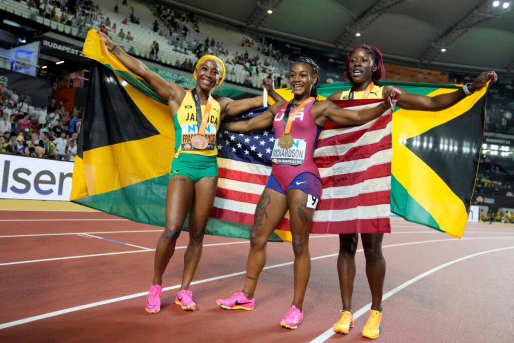 American and World women's 100m champ Sha'Carri Richardson, centre, with bronze medallist Shelly-Ann Fraser-Pryce, of Jamaica, left, and silver medalist Shericka Jackson, at the World Athletics Championships in Budapest, Hungary, Monday. - AP