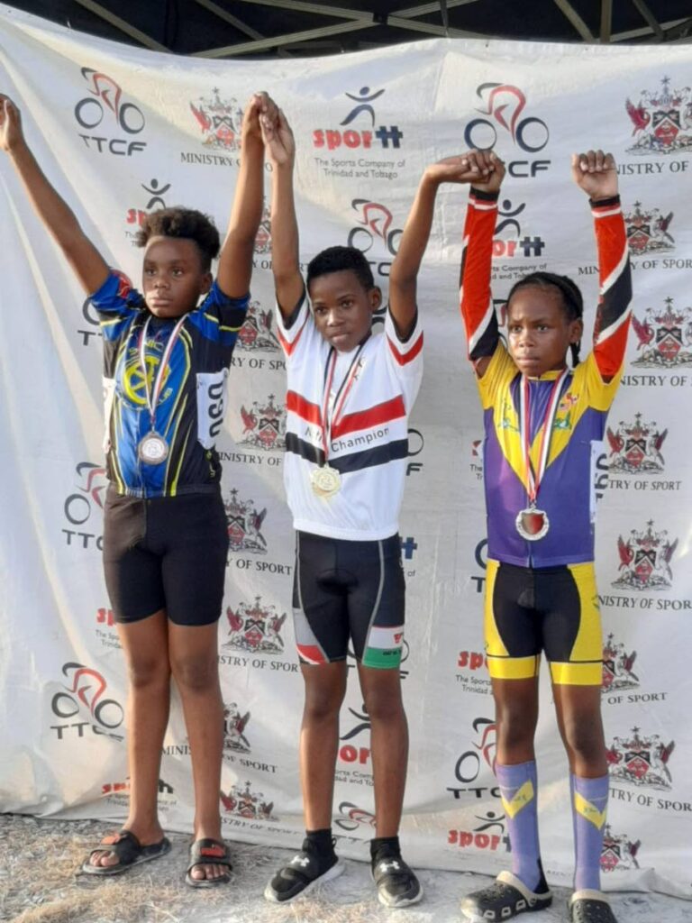 Under-13 boys cyclists Adiosie Lewis of Vapor Wake Multi-sport, middle, Tyler La Foucade of Hummingbird and Jeduthun Henry of Rigtech Sonics. Lewis, La Foucade and Henry claimed the first three places in both the time trial and criterium events at the TT Cycling Federation Youth Developers Road National Championships.
 - 
