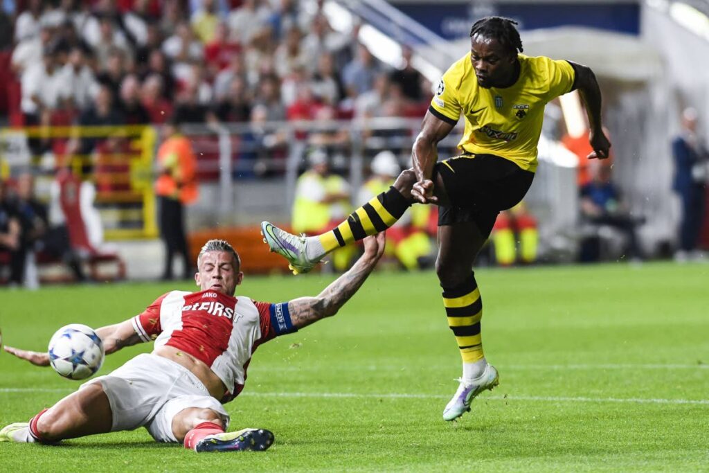 Antwerp's Belgian defender Toby Alderweireld, left, slides to block a shot from AEK Athens' Levi Garcia  during a first leg of the UEFA Champions League play-off on August 22. - 