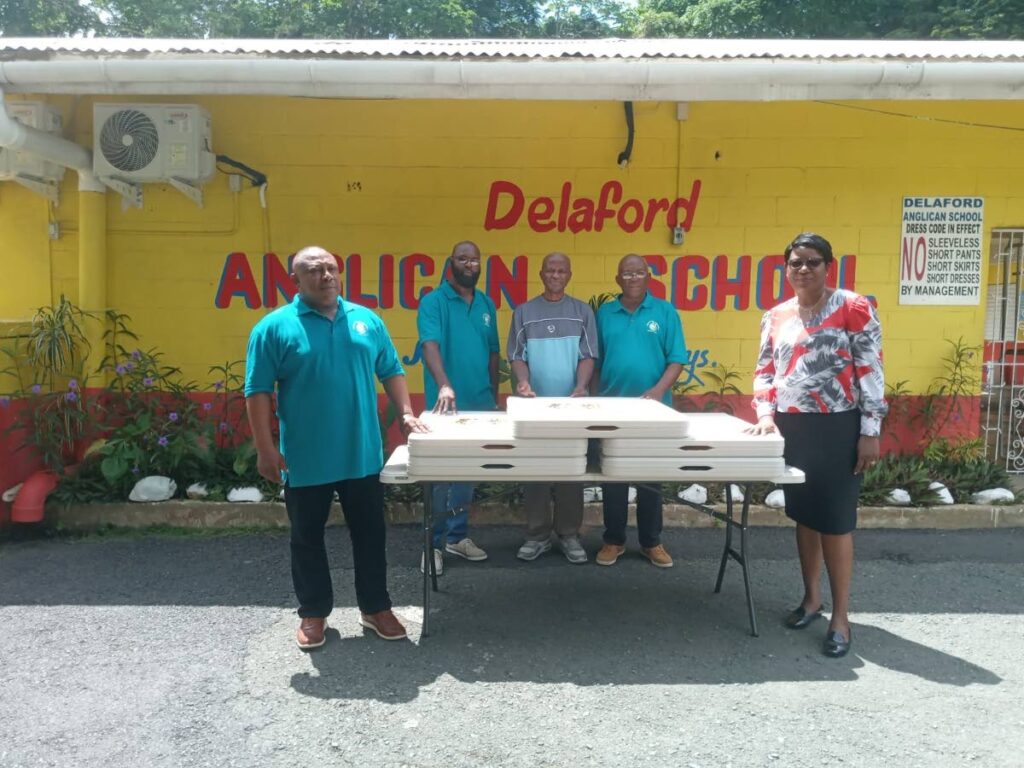 President of the Delaford (Tobago) Ambassadors: Trinidad Chapter Curtis Nimblett, left, presents six folding tables to principal of the Delaford Anglican Primary School Pearl Orr at the school’s premises on July 31. Also in photo are members, PRO Ansen Blackman, Carlton James and Ellis Edwards.

PHOTO: Courtesy Delaford  (Tobago) Ambassadors: Trinidad Chapter. - 