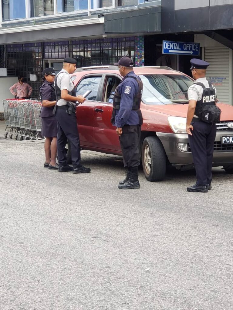 Municipal police question a driver during a road traffic exercise in Princes Town ono Wednesday. - 